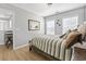 Cozy bedroom featuring ample natural light from the two windows and wood-look flooring at 1535 Harlow Ct., Myrtle Beach, SC 29579
