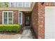 Close up of the red brick entrance showcasing manicured greenery and detailed architectural features at 1535 Harlow Ct., Myrtle Beach, SC 29579