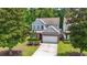 Charming two-story home with gray siding, brick accents, manicured landscaping, and a two-car garage at 1535 Harlow Ct., Myrtle Beach, SC 29579