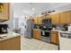 Well-lit kitchen featuring stainless steel appliances, light wood cabinets, and tile flooring at 1535 Harlow Ct., Myrtle Beach, SC 29579