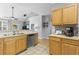 Bright kitchen with stainless steel appliances, wood cabinets, open to a living area at 1535 Harlow Ct., Myrtle Beach, SC 29579