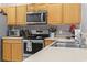 Close-up of the kitchen area with stainless steel microwave, oven, and sink at 1535 Harlow Ct., Myrtle Beach, SC 29579