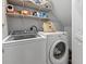 Laundry room with front load washer, dryer and storage shelves at 1535 Harlow Ct., Myrtle Beach, SC 29579