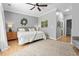 Well-lit main bedroom featuring a ceiling fan, wood-look flooring, and ensuite bathroom access at 1535 Harlow Ct., Myrtle Beach, SC 29579