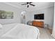 Spacious bedroom with ceiling fan, queen bed, dresser, and television at 1535 Harlow Ct., Myrtle Beach, SC 29579
