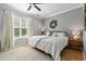 Cozy bedroom with a queen bed, ceiling fan, and decorative wreath at 1535 Harlow Ct., Myrtle Beach, SC 29579