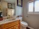 Elegant bathroom with a marble countertop, wooden vanity, and decorative accents at 1635 Southwood Dr., Surfside Beach, SC 29575