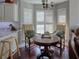 Cozy breakfast nook with a round table and two chairs positioned in front of bright windows with shutters at 1635 Southwood Dr., Surfside Beach, SC 29575