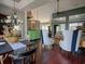 Open concept, high ceilings, dark wood floors, and stylish furniture create an inviting dining area at 1635 Southwood Dr., Surfside Beach, SC 29575