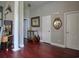 An open hallway with hardwood floors, decorative columns, and unique decor leading to various rooms at 1635 Southwood Dr., Surfside Beach, SC 29575