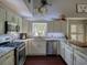 Beautiful kitchen featuring white cabinets, granite countertops, stainless appliances, and modern lighting fixtures at 1635 Southwood Dr., Surfside Beach, SC 29575