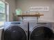 Laundry room with front loading washer and dryer, window, and shelving at 1635 Southwood Dr., Surfside Beach, SC 29575