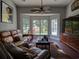 Bright living room with large windows offers views of the backyard and a comfortable seating area at 1635 Southwood Dr., Surfside Beach, SC 29575