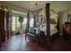 Opulent primary bedroom featuring a four-poster bed, ample natural light, and hardwood flooring at 1635 Southwood Dr., Surfside Beach, SC 29575