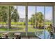 Relaxing screened porch showcases views of a tranquil pond with landscaped surroundings at 1635 Southwood Dr., Surfside Beach, SC 29575