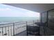 Oceanfront balcony featuring outdoor seating and panoramic views of the sandy beach and ocean at 1690 N Waccamaw Dr. # 504, Garden City Beach, SC 29576