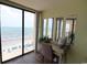 Bedroom featuring vanity area with ocean views offering lots of natural light for doing makeup at 1690 N Waccamaw Dr. # 504, Garden City Beach, SC 29576