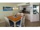 Bright dining area with seating for six, elegant chandelier, and tile flooring at 1690 N Waccamaw Dr. # 504, Garden City Beach, SC 29576