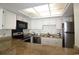 Well-lit kitchen with granite counters, stainless steel appliances, and white cabinetry at 1690 N Waccamaw Dr. # 504, Garden City Beach, SC 29576