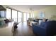 Spacious condo living room with ceiling fan, comfy seating and access to balcony with ocean views at 1690 N Waccamaw Dr. # 504, Garden City Beach, SC 29576