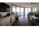 Relax in this inviting living room with balcony access and amazing ocean views from the condo at 1690 N Waccamaw Dr. # 504, Garden City Beach, SC 29576
