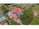 Aerial view of a property featuring a red metal roof, spacious yard, and additional structures at 1700 Longleaf Dr., Myrtle Beach, SC 29575