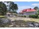 A large backyard includes a garage and landscaping around the house with a red roof at 1700 Longleaf Dr., Myrtle Beach, SC 29575