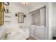 Bright bathroom with double sink vanity, decorative lighting, and a walk-in tub at 1700 Longleaf Dr., Myrtle Beach, SC 29575