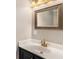 Bathroom features a classic framed mirror, quartz countertop, and gold faucet at 1700 Longleaf Dr., Myrtle Beach, SC 29575