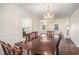 Formal dining room features hardwood floors, chandelier, and view into the kitchen at 1700 Longleaf Dr., Myrtle Beach, SC 29575