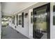 Inviting front porch showcasing a decorative glass door, black shutters, and elegant exterior lighting at 1700 Longleaf Dr., Myrtle Beach, SC 29575
