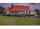 Charming home with a covered front porch, red roof, and well-maintained front yard at 1700 Longleaf Dr., Myrtle Beach, SC 29575