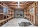 An unfinished garage with exposed walls and wooden shelving for potential storage at 1700 Longleaf Dr., Myrtle Beach, SC 29575