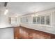 Bright living room with hardwood floors, built-in shelving, and large windows at 1700 Longleaf Dr., Myrtle Beach, SC 29575