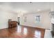 Spacious living room featuring hardwood floors, fireplace, natural light, and elegant chandelier lighting at 1700 Longleaf Dr., Myrtle Beach, SC 29575
