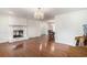 Spacious living room with hardwood floors, a fireplace, and elegant chandeliers, perfect for entertaining at 1700 Longleaf Dr., Myrtle Beach, SC 29575