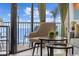 Relaxing balcony seating with clear ocean views through glass doors and decorative curtains at 201 74Th Ave N Ocean Blvd. # 2627, Myrtle Beach, SC 29572