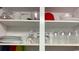 Kitchen cupboard featuring a variety of glassware, plates, and bowls neatly arranged on shelves at 201 74Th Ave N Ocean Blvd. # 2627, Myrtle Beach, SC 29572