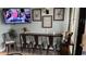 Bar-style dining area with seating for four, TV, and decorative coastal-themed wall art at 201 74Th Ave N Ocean Blvd. # 2627, Myrtle Beach, SC 29572