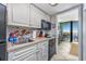 Cozy kitchenette with white cabinets, essential appliances, and a pass-through to the balcony view at 201 74Th Ave N Ocean Blvd. # 2627, Myrtle Beach, SC 29572