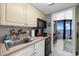 Well-equipped kitchenette featuring modern appliances and a clear view of the ocean from the balcony at 201 74Th Ave N Ocean Blvd. # 2627, Myrtle Beach, SC 29572