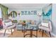 Comfortable living room featuring a plush couch, decorative pillows, and a beach-themed accent wall at 201 74Th Ave N Ocean Blvd. # 2627, Myrtle Beach, SC 29572