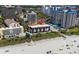 Aerial view of beachfront condo community with a pool, manicured lawn, steps to beach access and parking at 201 76Th Ave. N # D-3, Myrtle Beach, SC 29572