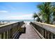 Convenient beach access with wood boardwalk, bench, and nearby beach at 201 76Th Ave. N # D-3, Myrtle Beach, SC 29572
