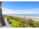 Expansive beach view from the balcony, featuring beach access, and manicured lawns, near the ocean's edge at 201 76Th Ave. N # D-3, Myrtle Beach, SC 29572