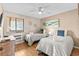 Bright bedroom with two twin beds, ceiling fan, and large sunny window at 201 76Th Ave. N # D-3, Myrtle Beach, SC 29572