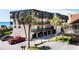 Coastal condo complex with covered parking, lush palms, and ocean views from private balconies at 201 76Th Ave. N # D-3, Myrtle Beach, SC 29572