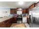 Well-equipped kitchen with stainless steel appliances and stylish dark wood cabinets at 201 76Th Ave. N # D-3, Myrtle Beach, SC 29572