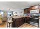 Open kitchen design offering dark wooden cabinetry and modern appliances near the living room at 201 76Th Ave. N # D-3, Myrtle Beach, SC 29572