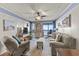 Cozy living room with comfortable seating, a ceiling fan, and access to a private balcony with stunning ocean views at 201 76Th Ave. N # D-3, Myrtle Beach, SC 29572
